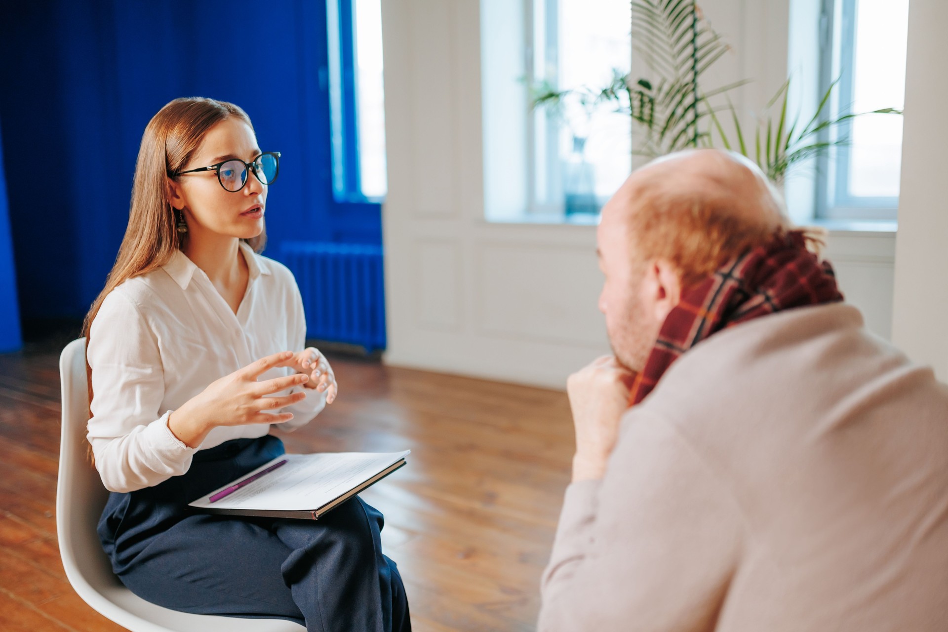 Engaging discussion between therapist and client in modern office setting